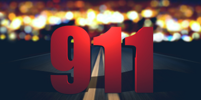 The number 911 is written in red on the side of a road.