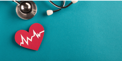 A red heart with a heartbeat on it next to a stethoscope on a blue background.