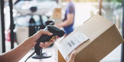 A person is using a barcode scanner to scan a box.
