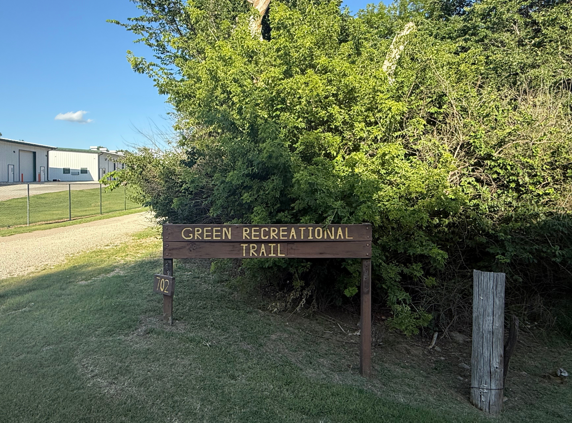 A wooden sign for the green recreational trail