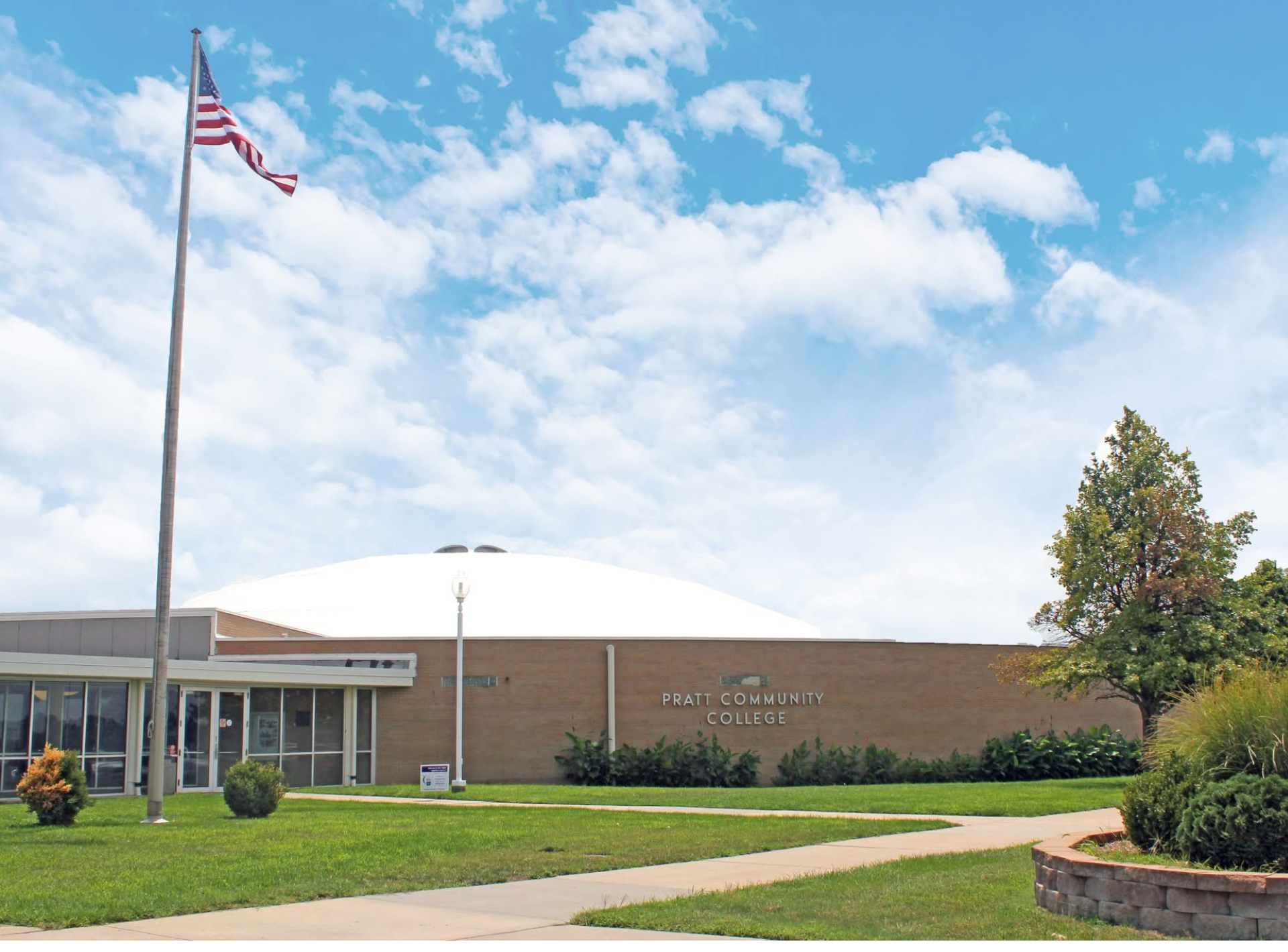 An american flag is flying in front of a building