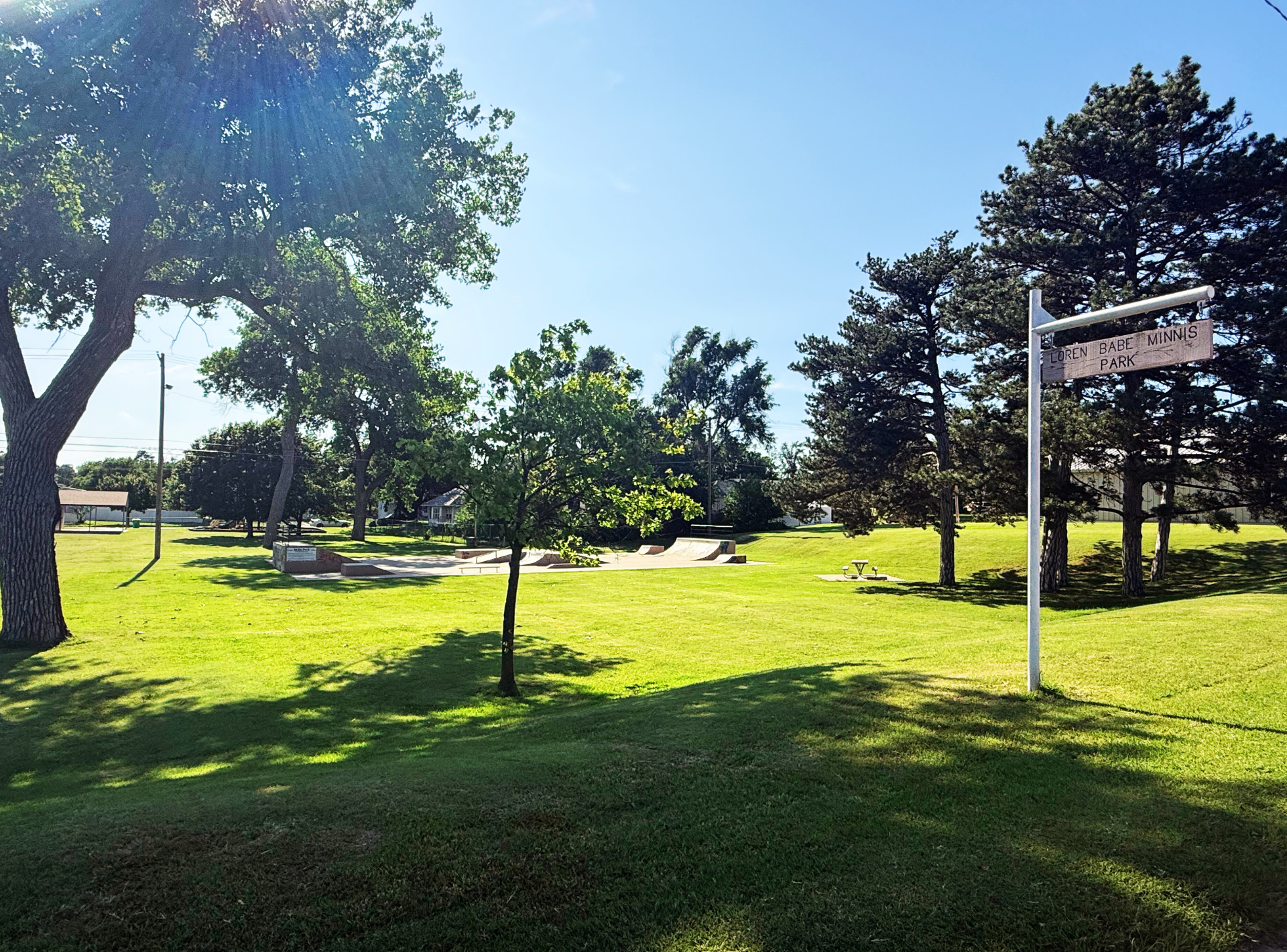 A park with trees and a sign that says park