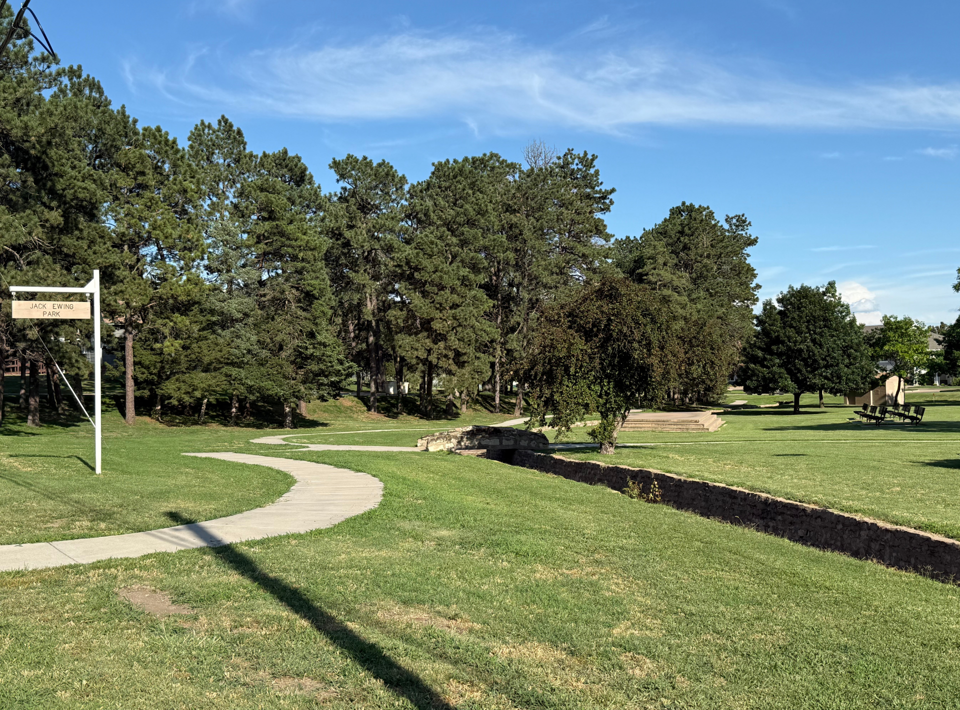 There is a sign in the middle of the park.