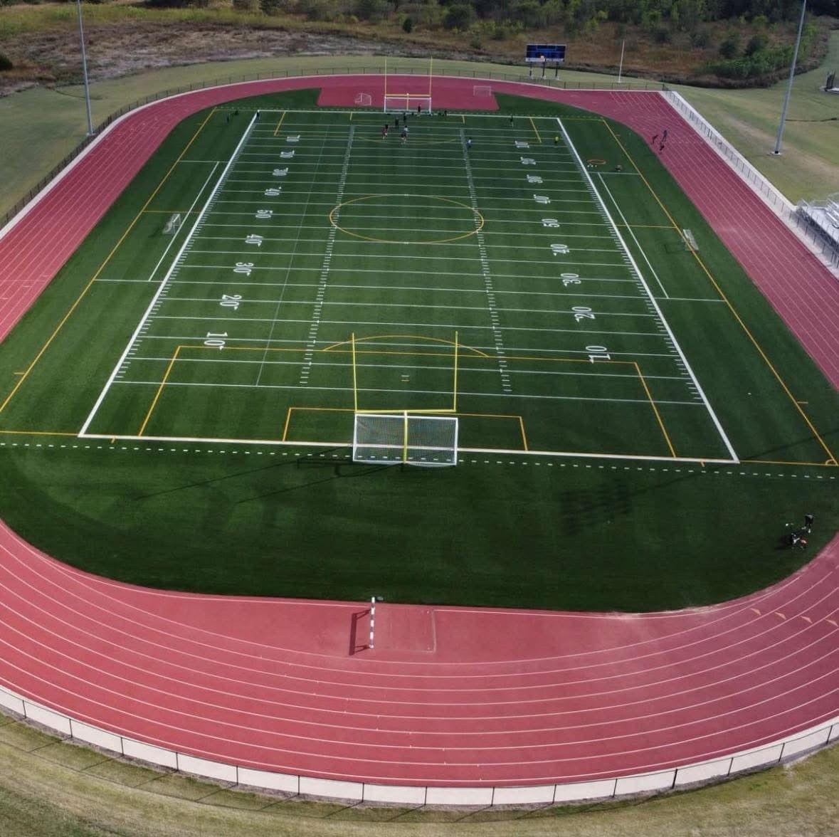 An aerial view of a football field and track