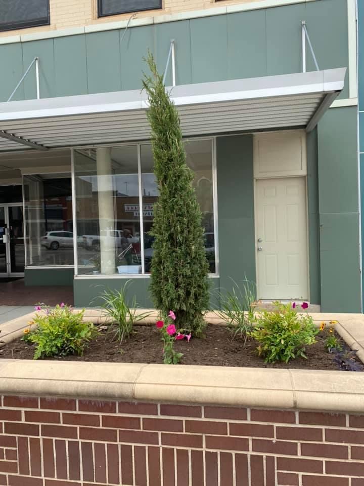 A brick wall with a planter in front of a building
