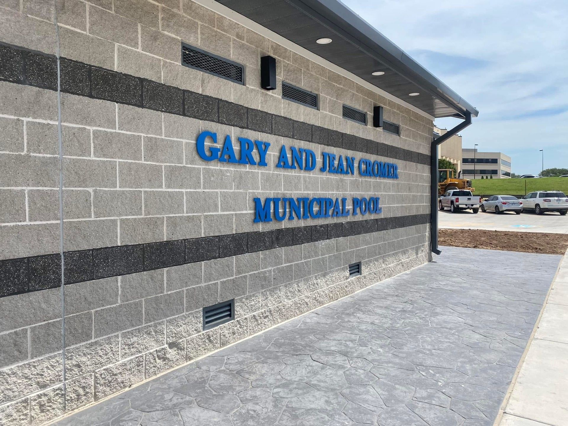 A brick wall with the words gary and juan crooks municipal pool written on it.
