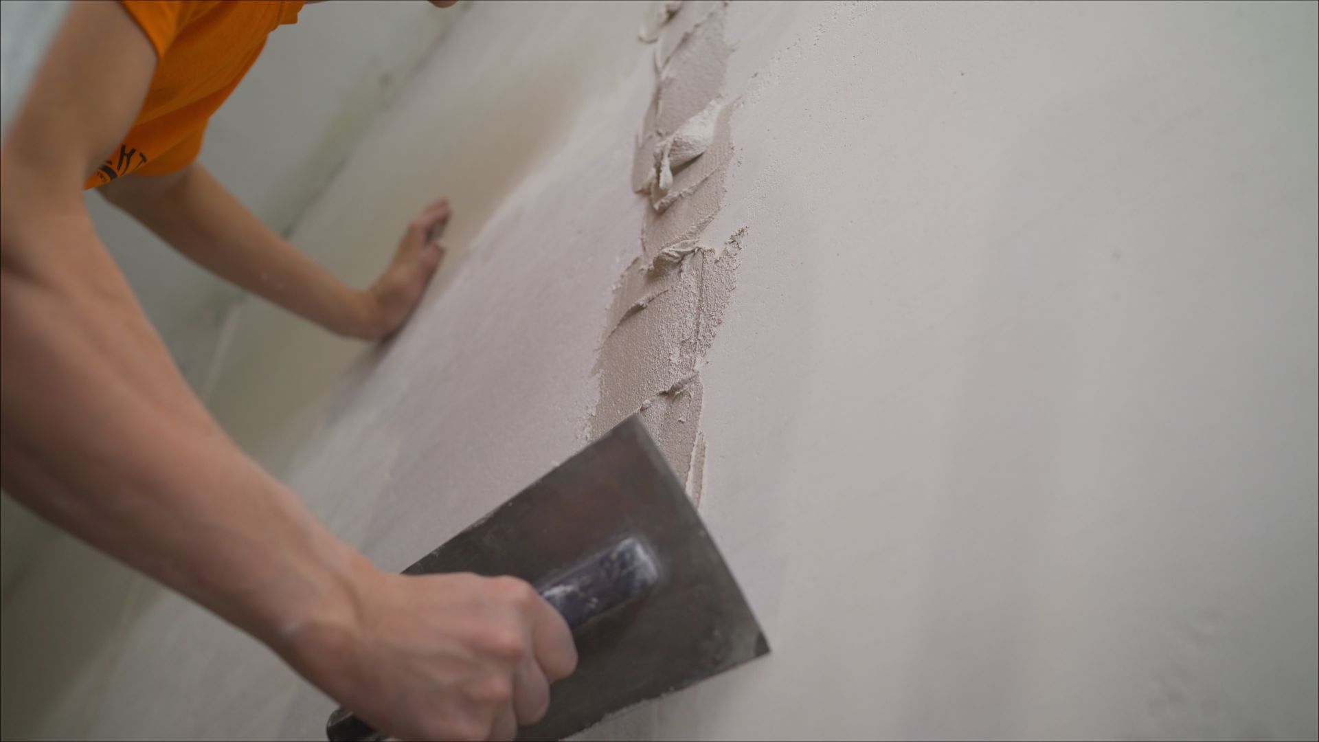 Worker using trowel for plastering concrete wall for foundation repair and residential 