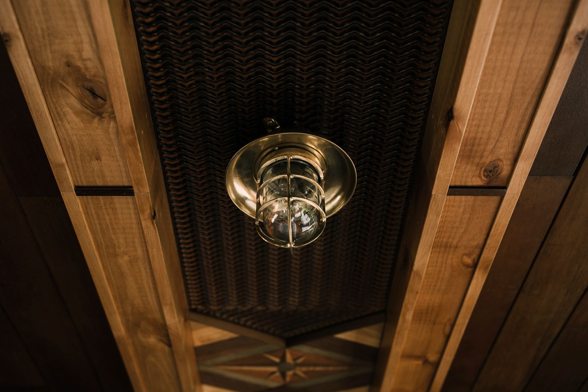 A light is hanging from the ceiling of a wooden building.
