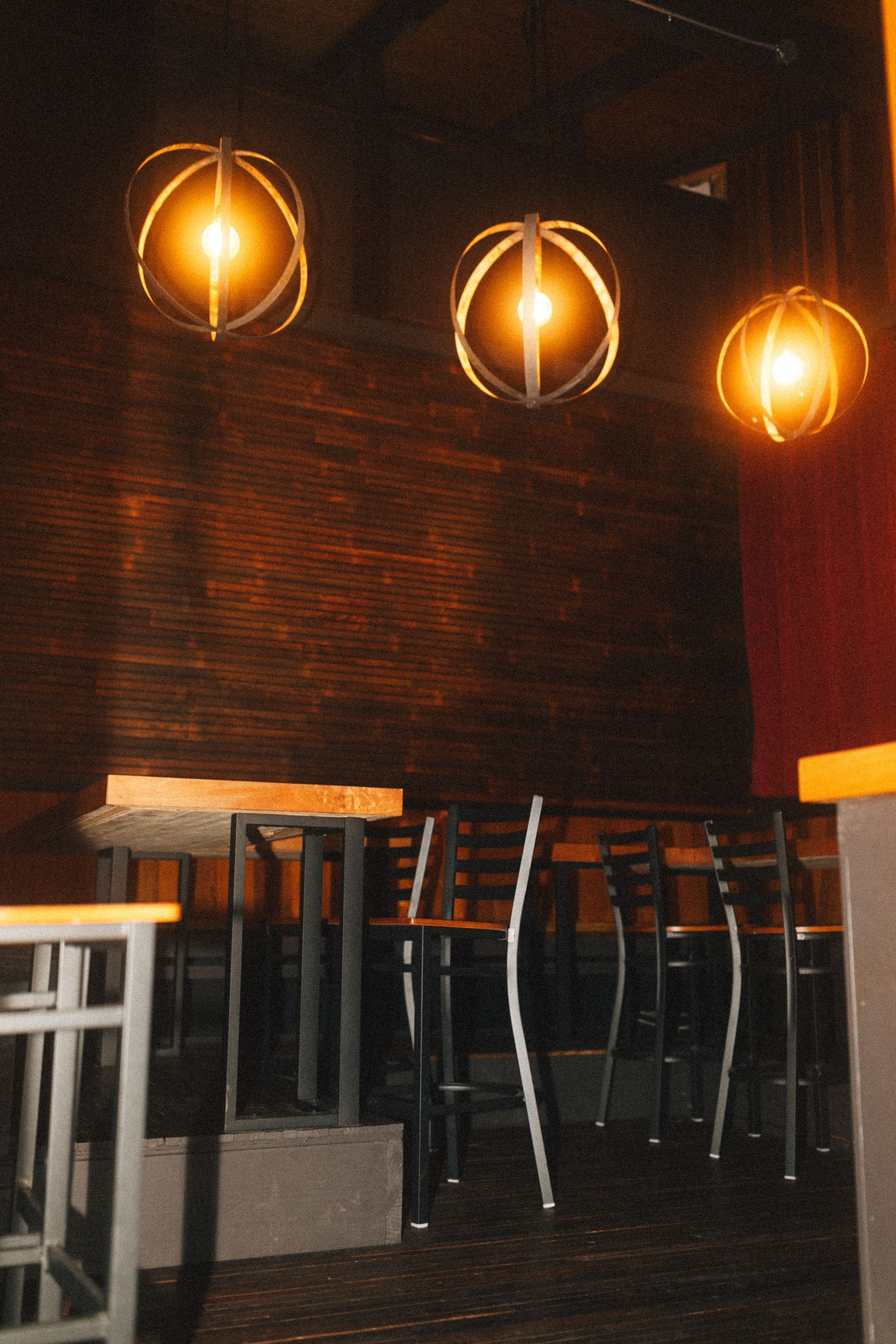 Two women are standing at a table looking at papers.
