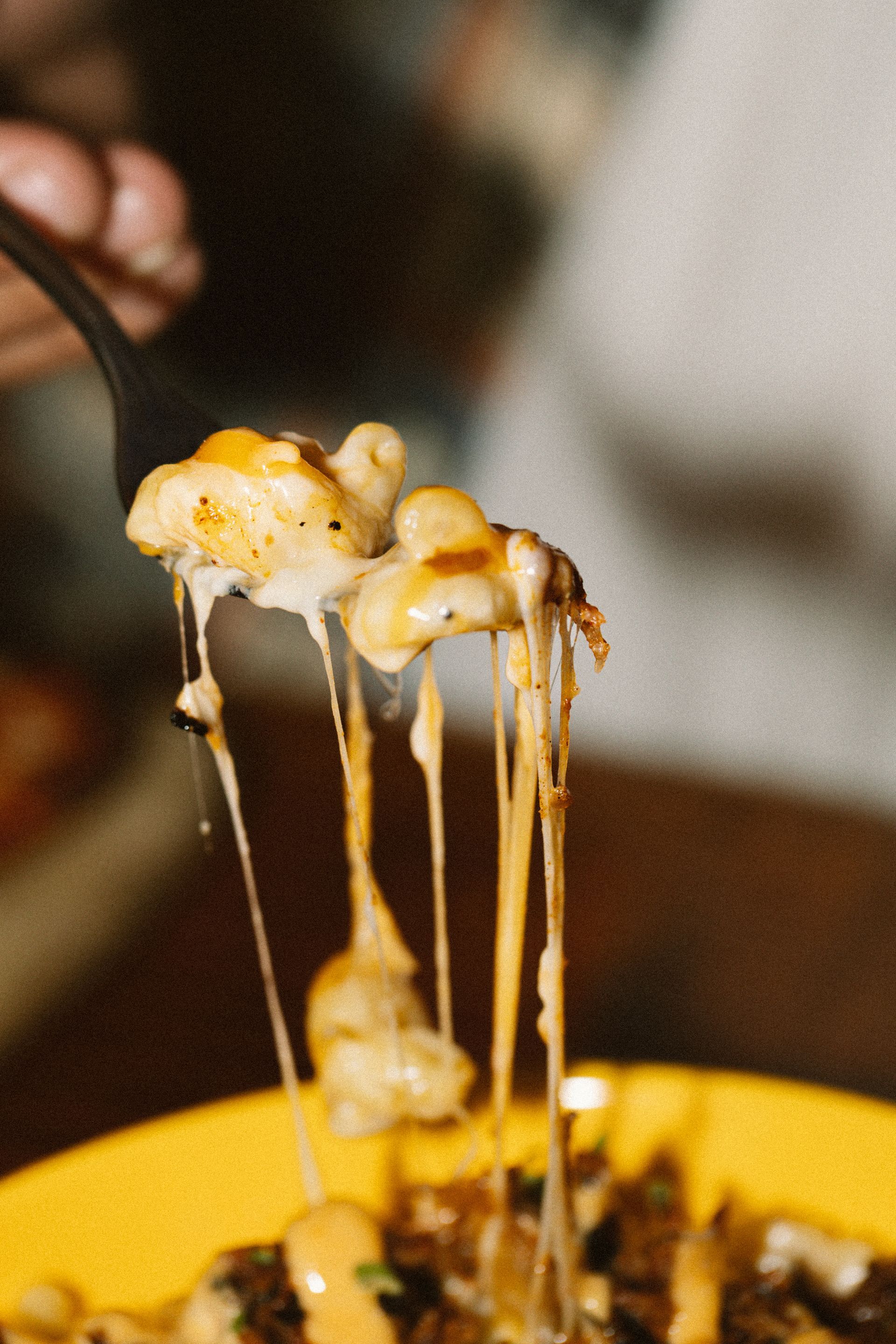 A row of tables and chairs in a dark room with a sign that says iu