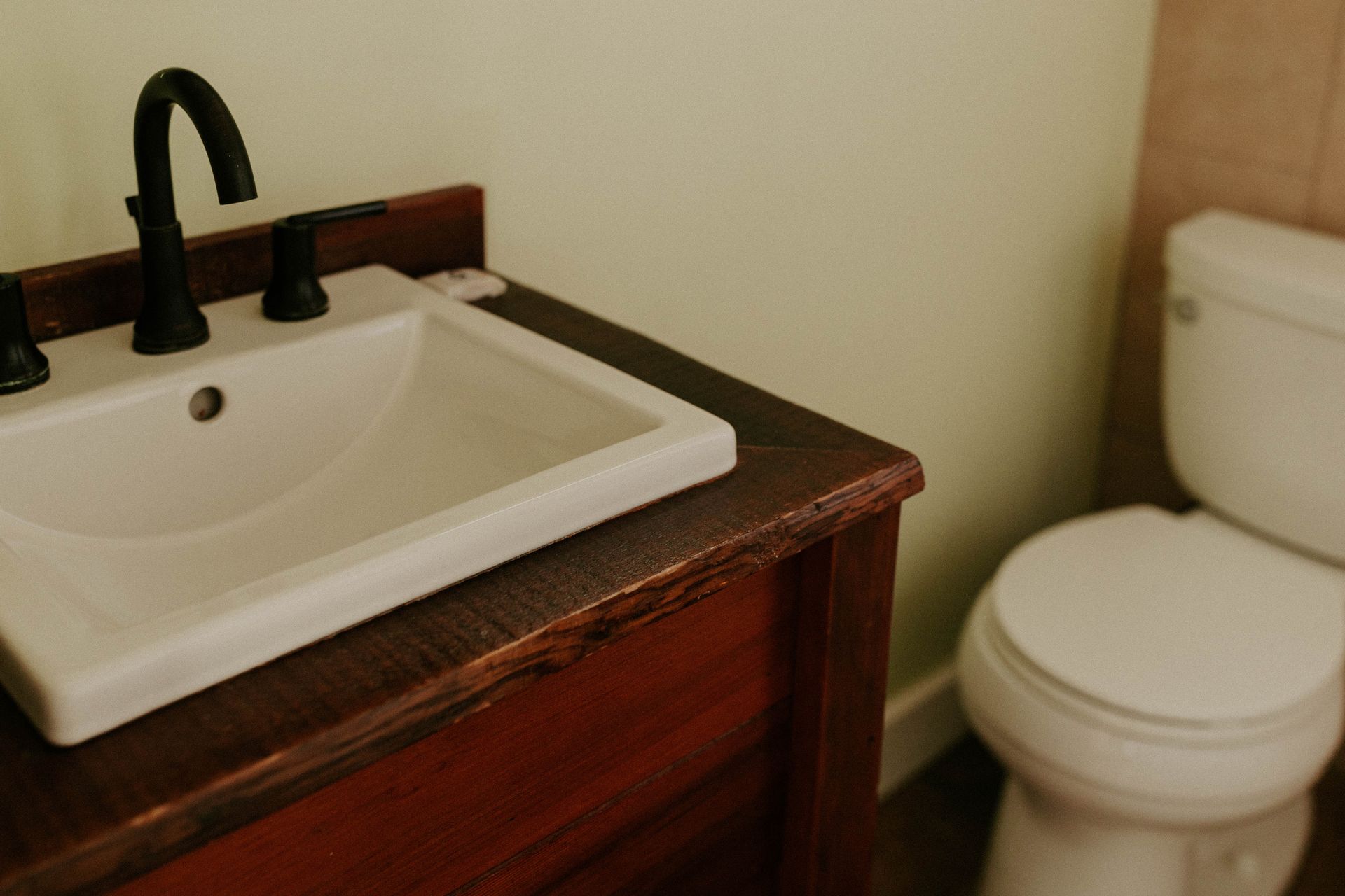 A bathroom with a sink and toilet in it.