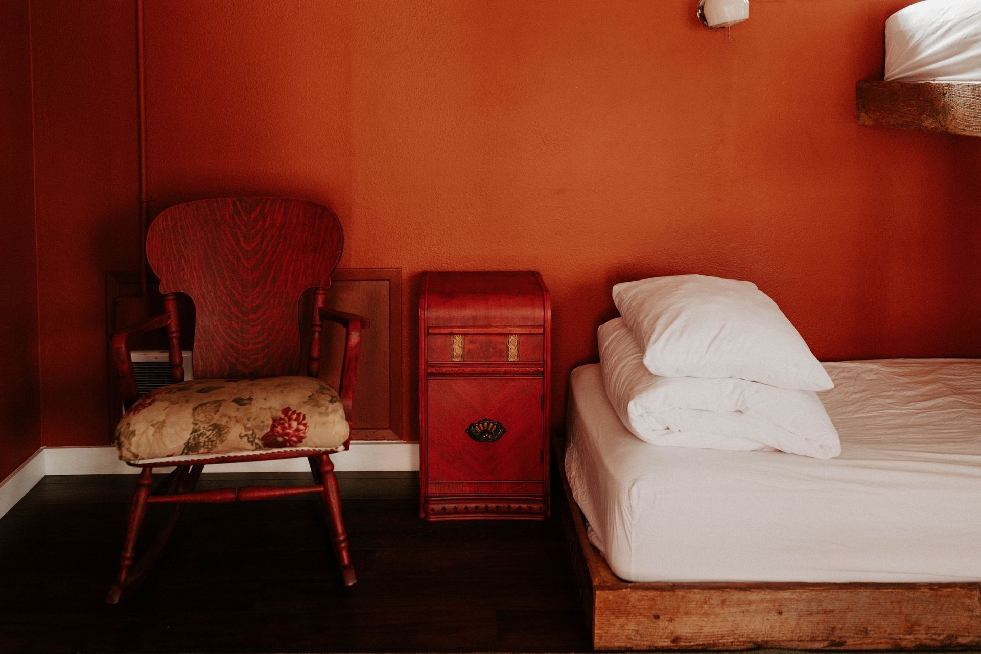 There is a chair and a bed in the room.