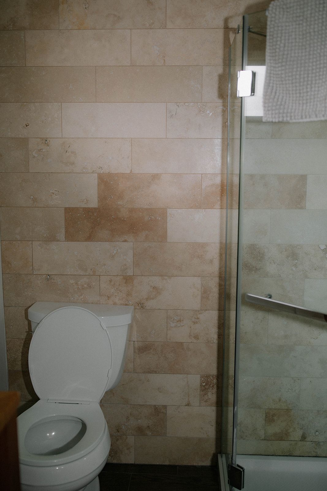 A bathroom with a toilet , shower and bathtub.