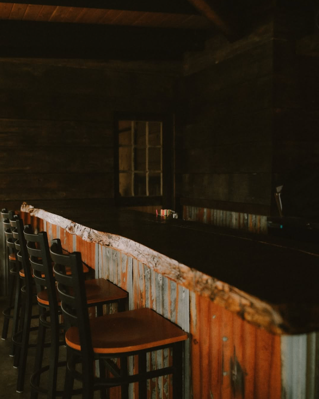 A table set for a wedding reception with a chalkboard table number.
