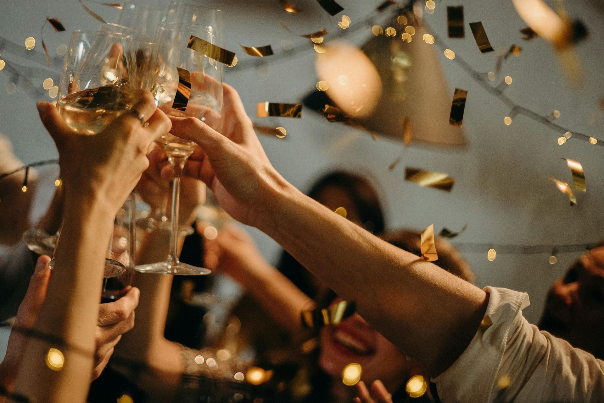 A group of people are toasting with champagne glasses at a party.