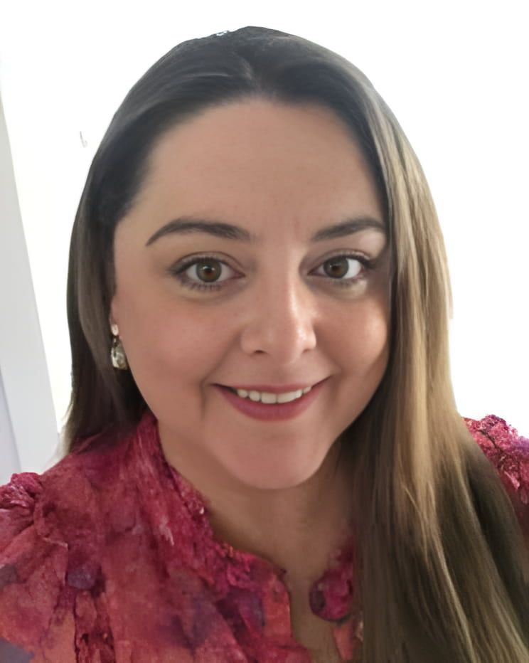 A woman in a pink shirt is smiling for the camera — Linda Emery & Associates In Gosford, NSW