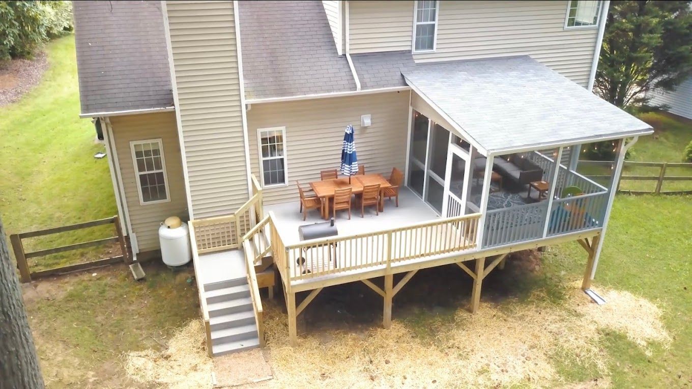 An aerial view of a house with a screened in porch.