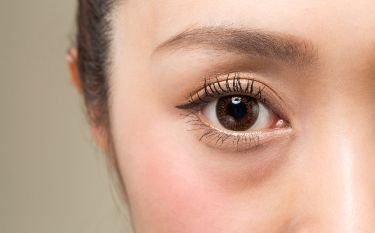 A close up of a woman 's eye with makeup on.