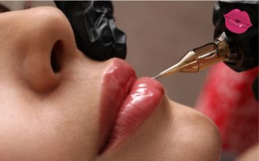 A woman is getting a tattoo on her lips.