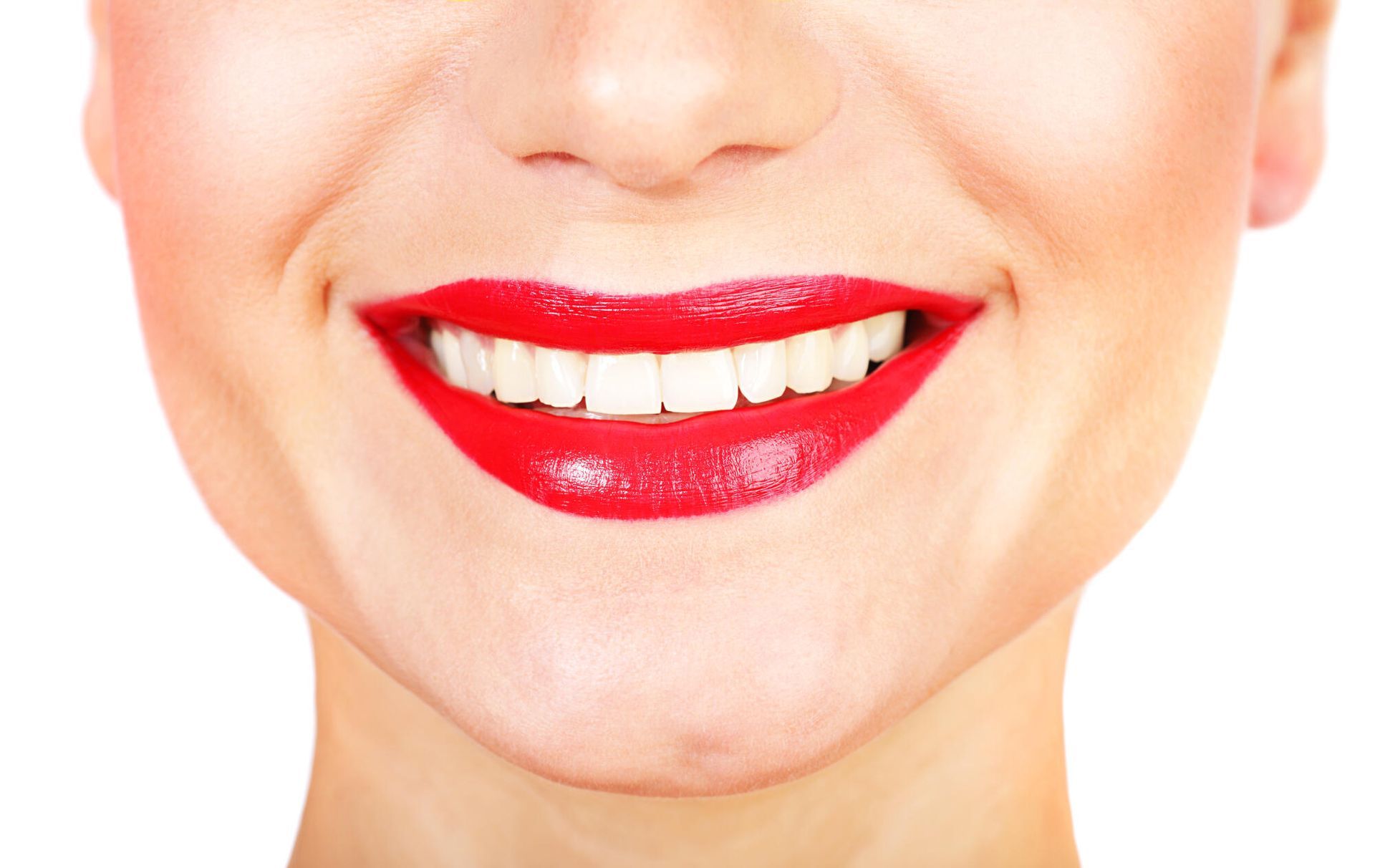 A close up of a woman 's mouth with red lipstick and white teeth.