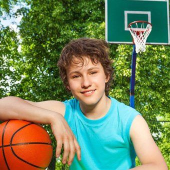 teen playing basketball