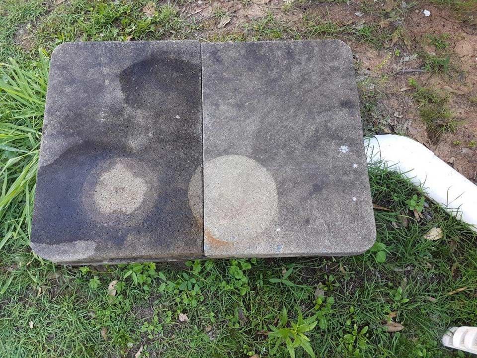 Square, dirty drain with a blue tool inside. Grimy, dark interior.