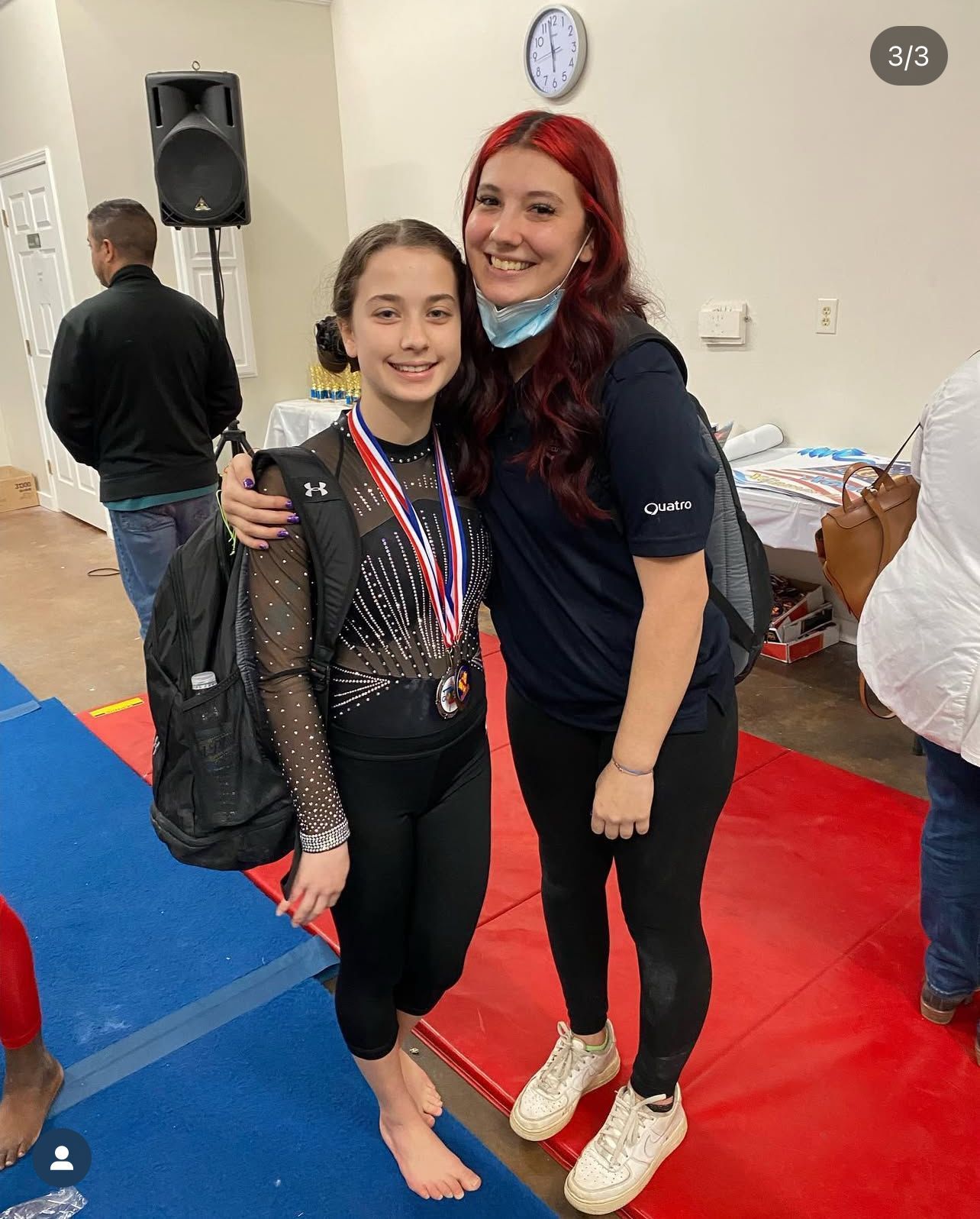 A woman in an brown sweater smiling for the camera.