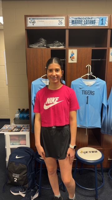 A young woman posing in a locker room. 