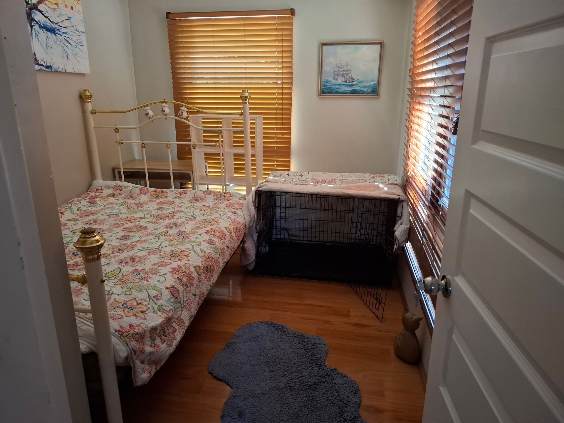 Dog bed on floor, desk with decorations. Various items on desk, including a Christmas-themed display.