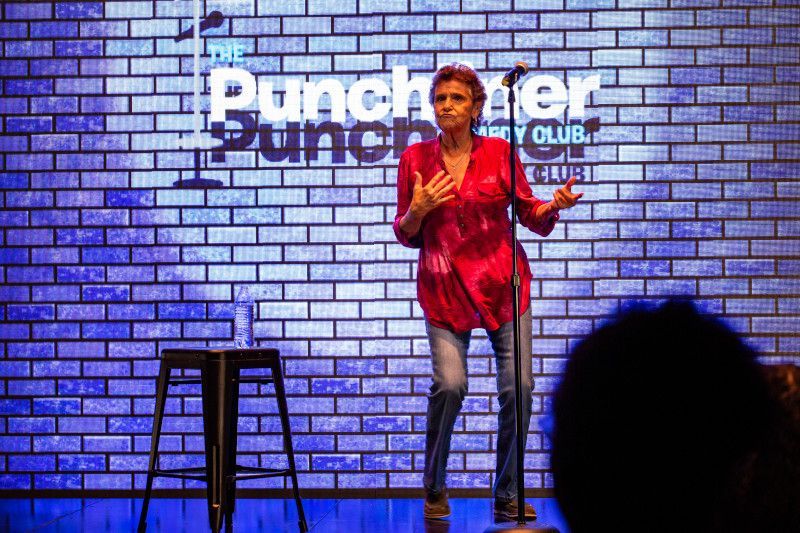 Woman in red shirt on stage at