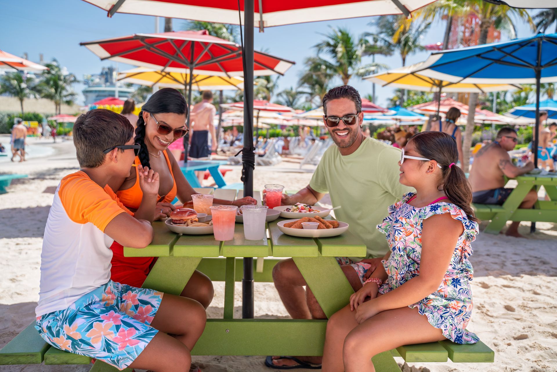 Photo of a family sitting at a picnic table at Perfect Day CocoCay by Royal Caribbean