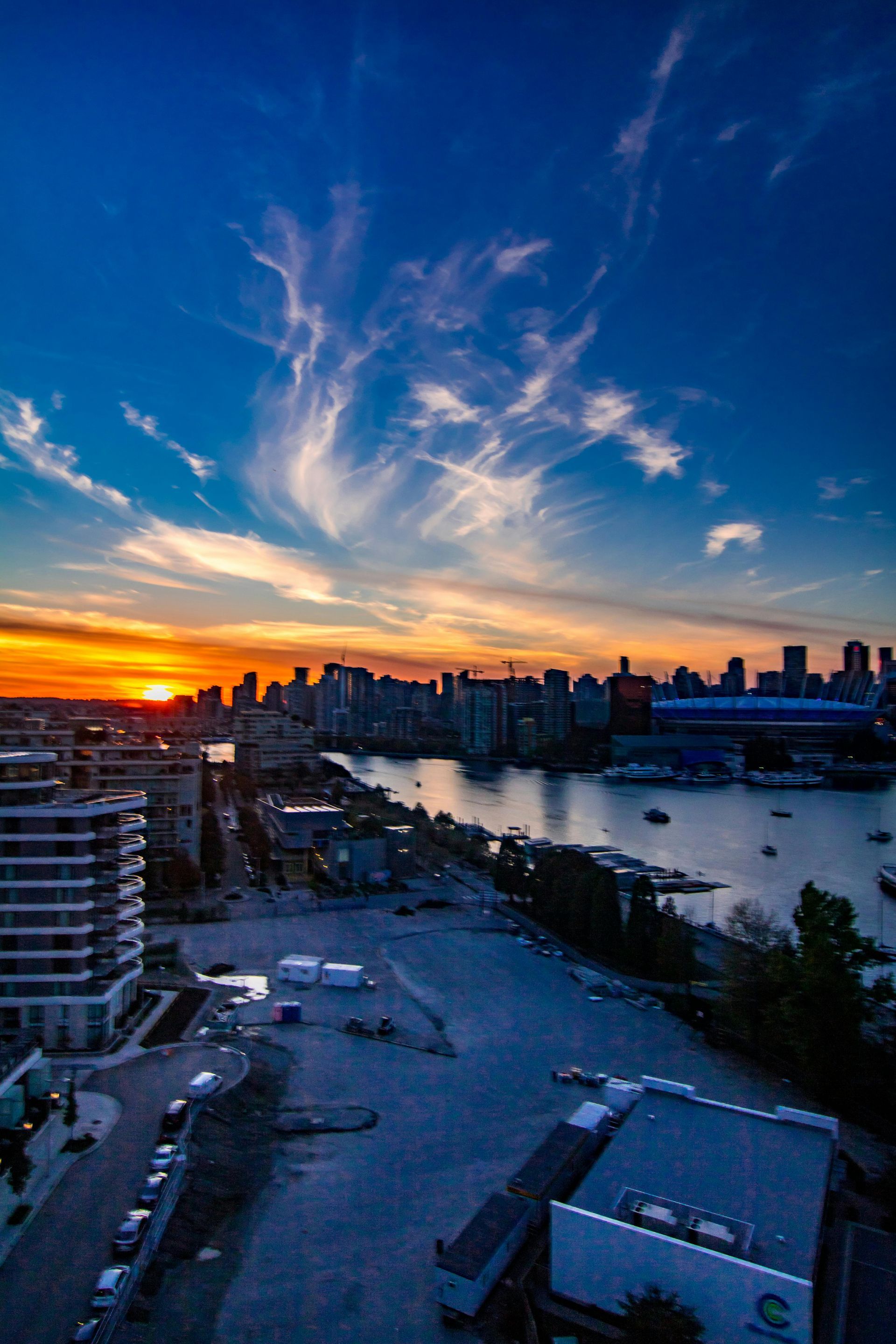 Sunset over Vancouver, Canada. City skyline, water, and colorful clouds.