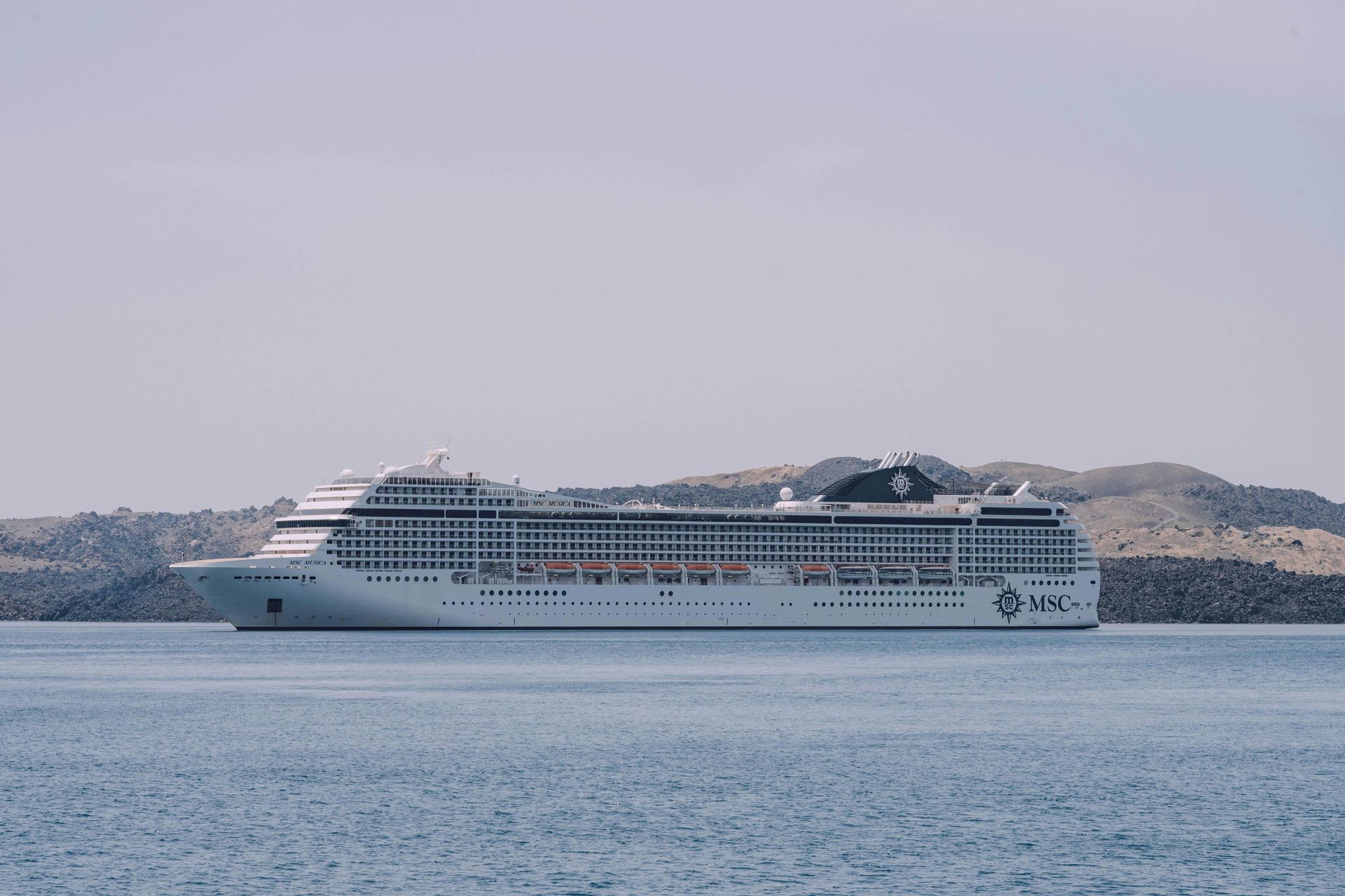 A view of a smaller MSC cruise ship as it departs an unknown port.