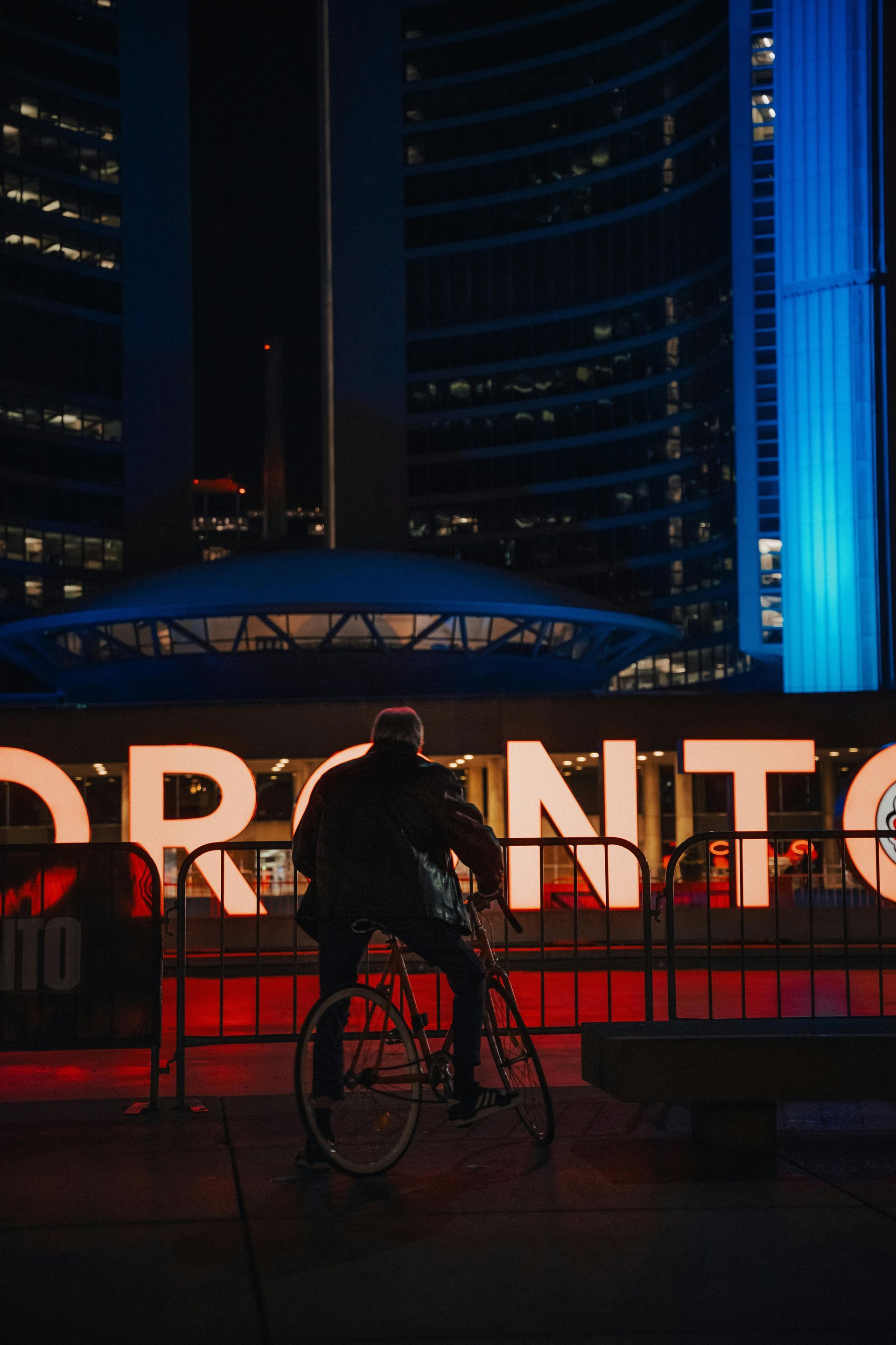 Person on bicycle in front of the illuminated 