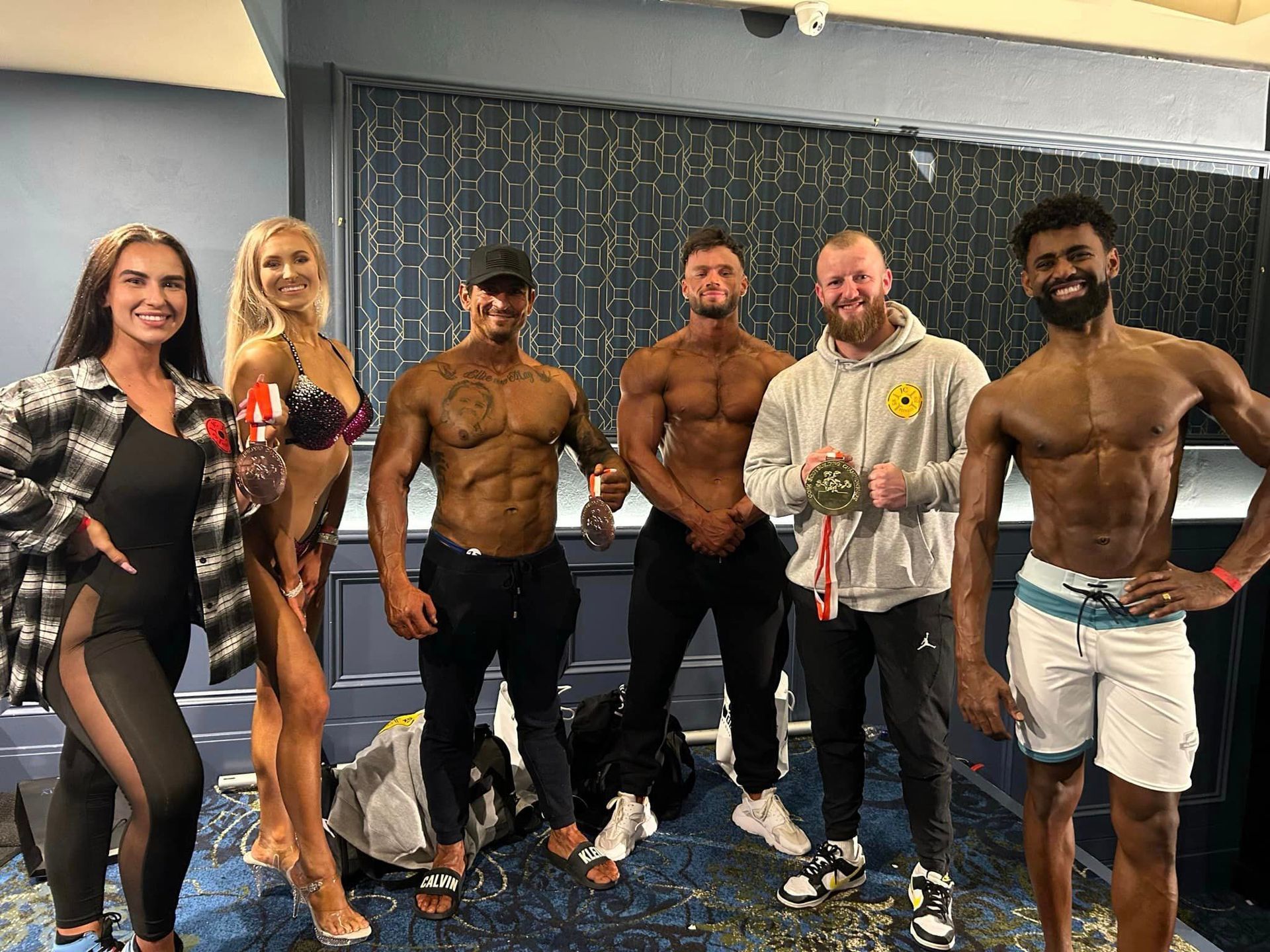 a group of JC Fitness Cork members showing their body building awards in Cork.