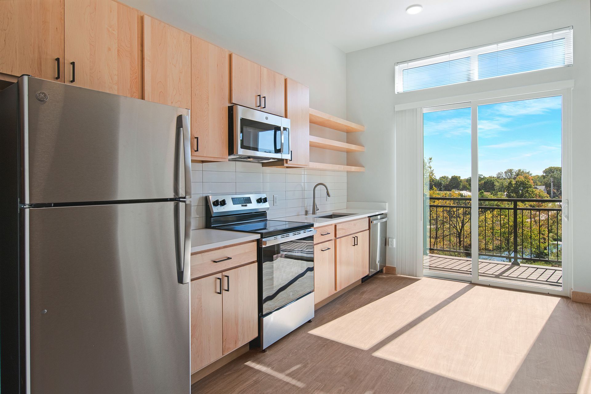 A kitchen with stainless steel appliances and wooden cabinets