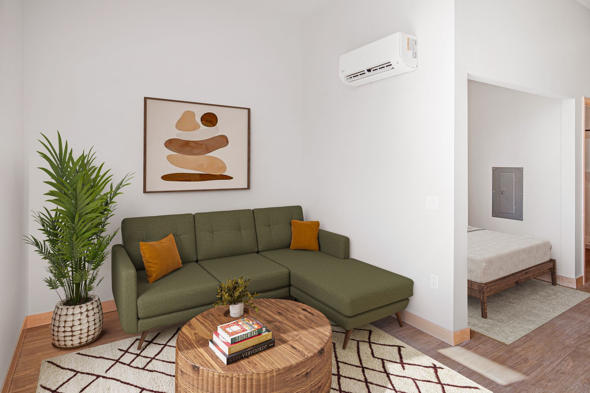 A living room with a green sectional couch and a wicker coffee table.