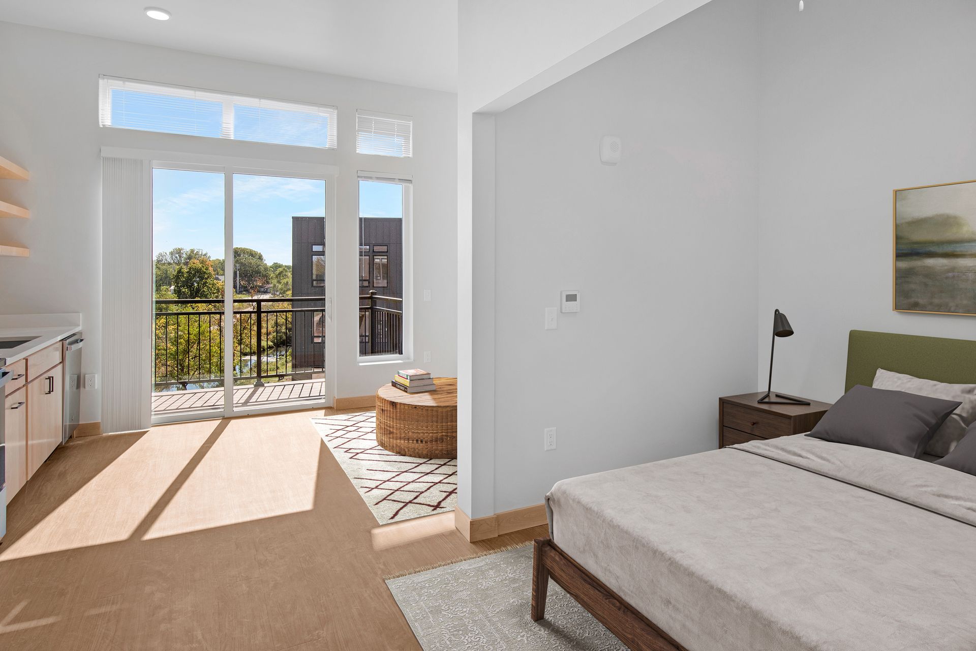 A bedroom with a bed , sliding glass doors , and a balcony.