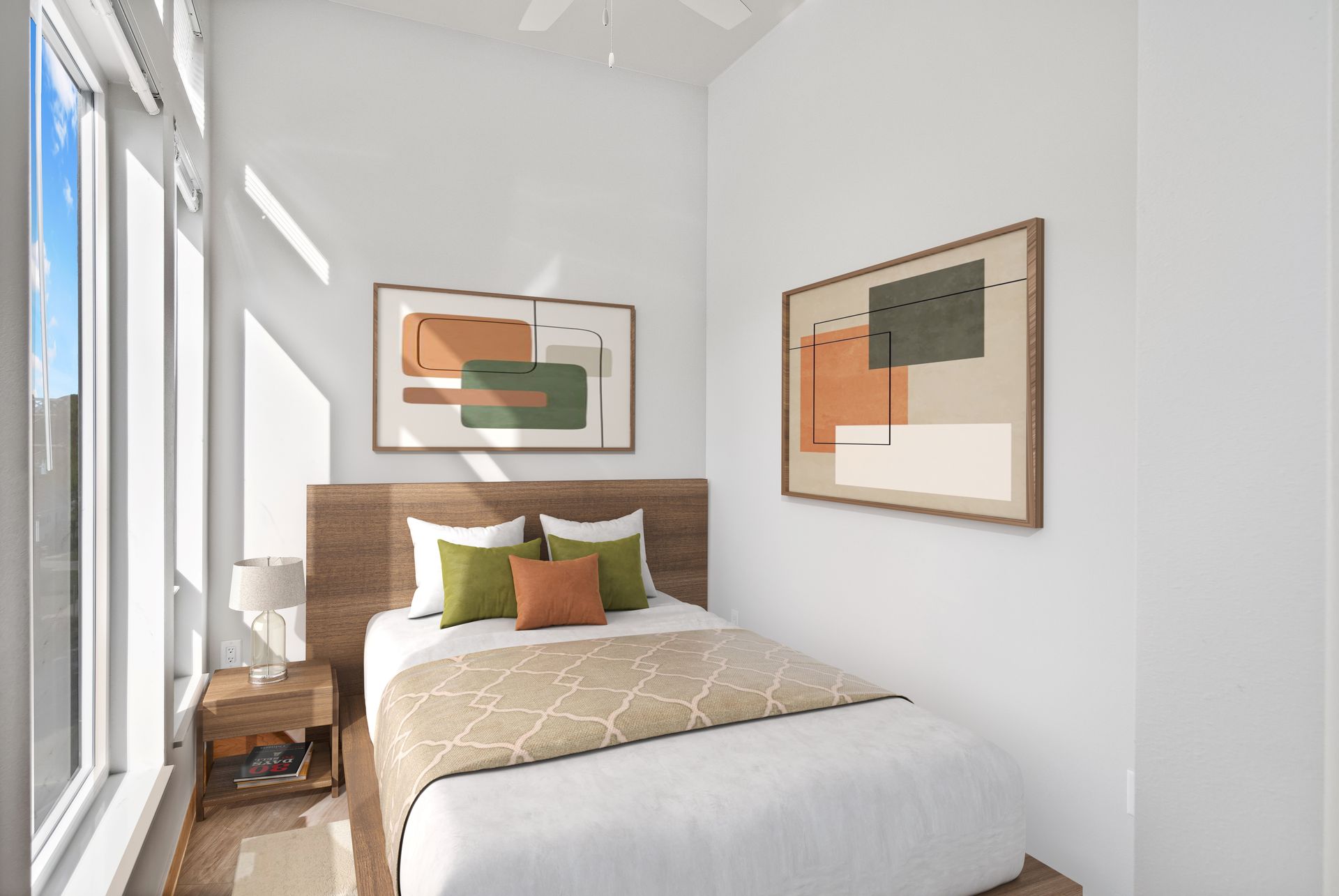 A bedroom with a bed and two paintings on the wall.