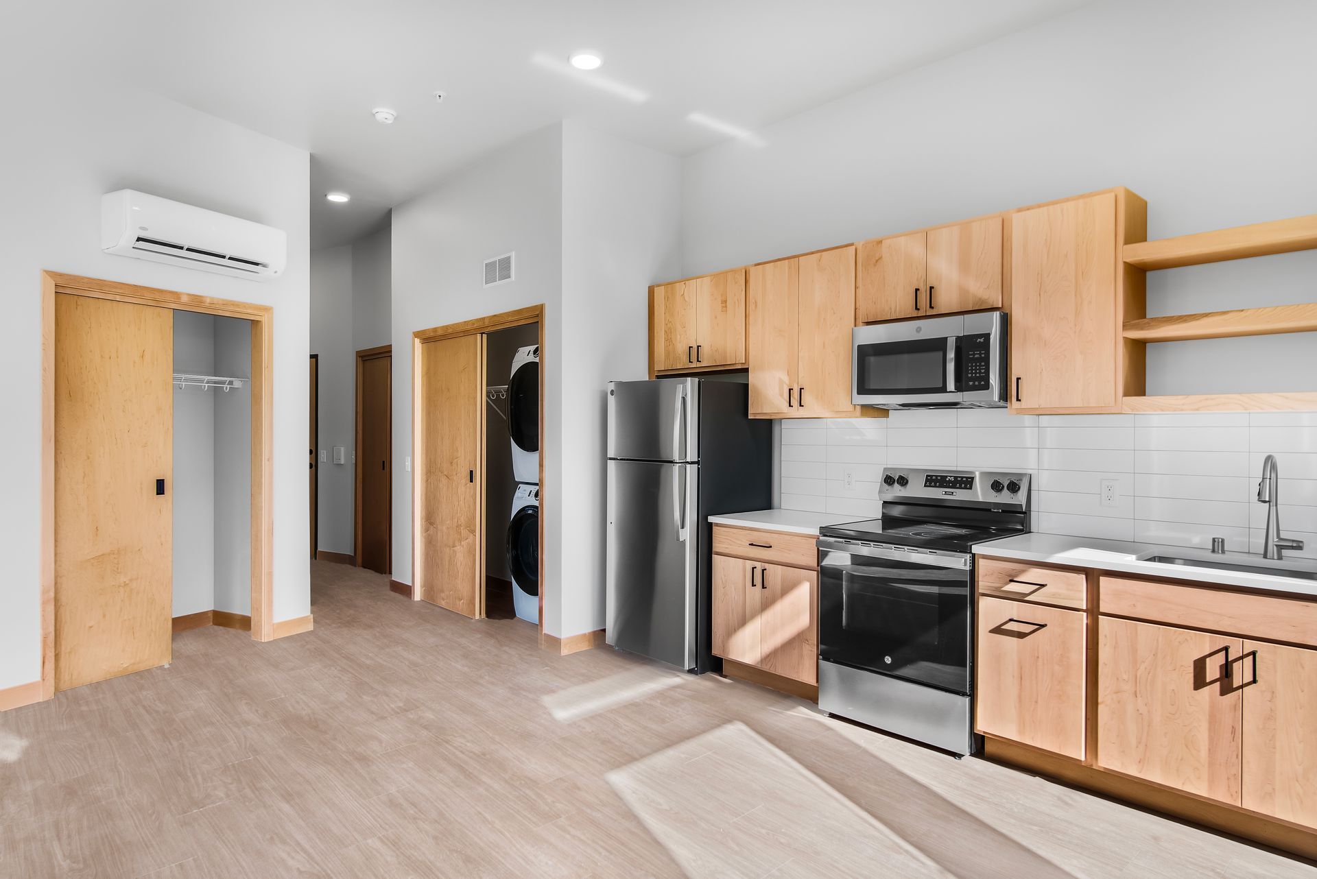A kitchen with stainless steel appliances and wooden cabinets