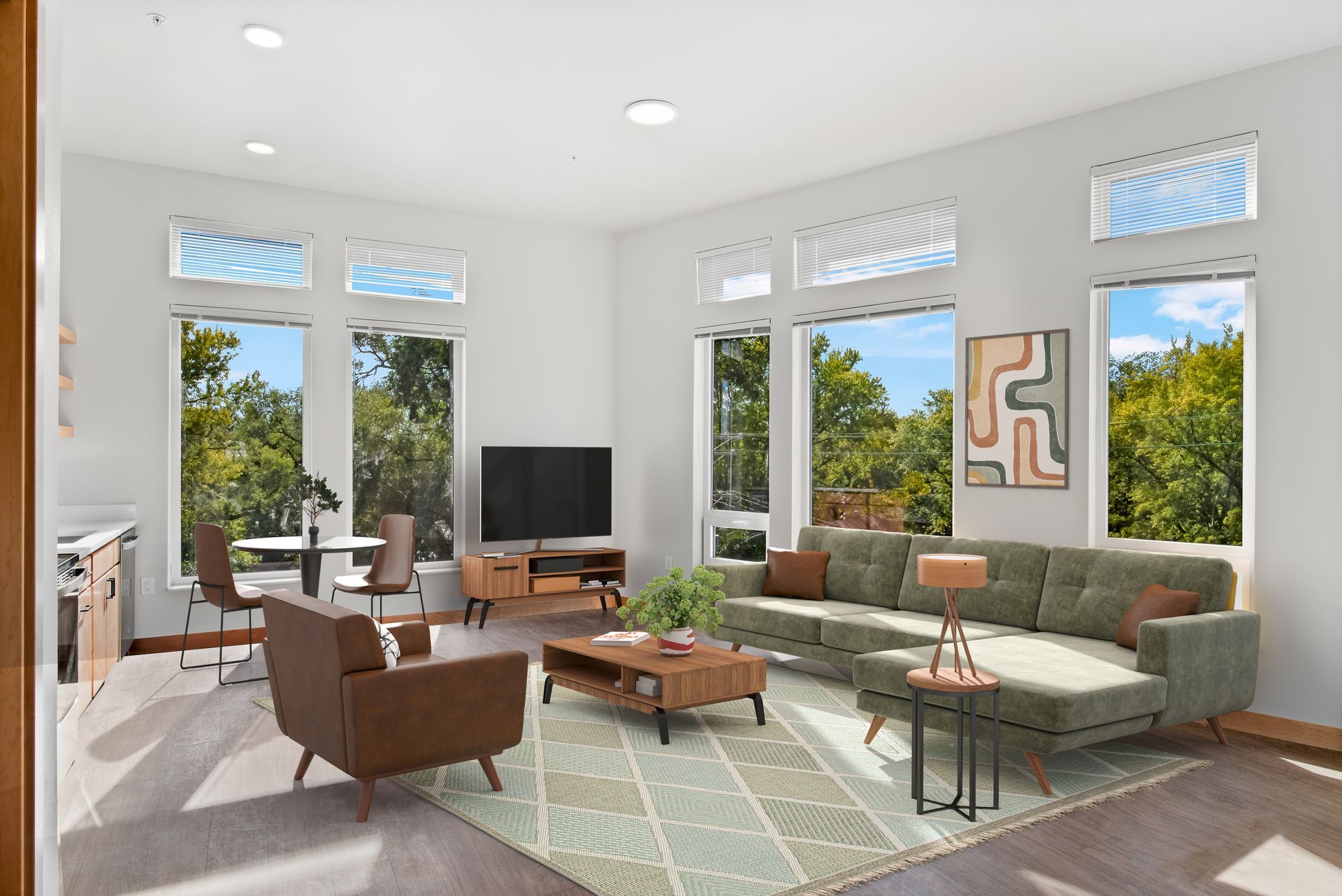 A living room with a couch , chairs , coffee table and television.