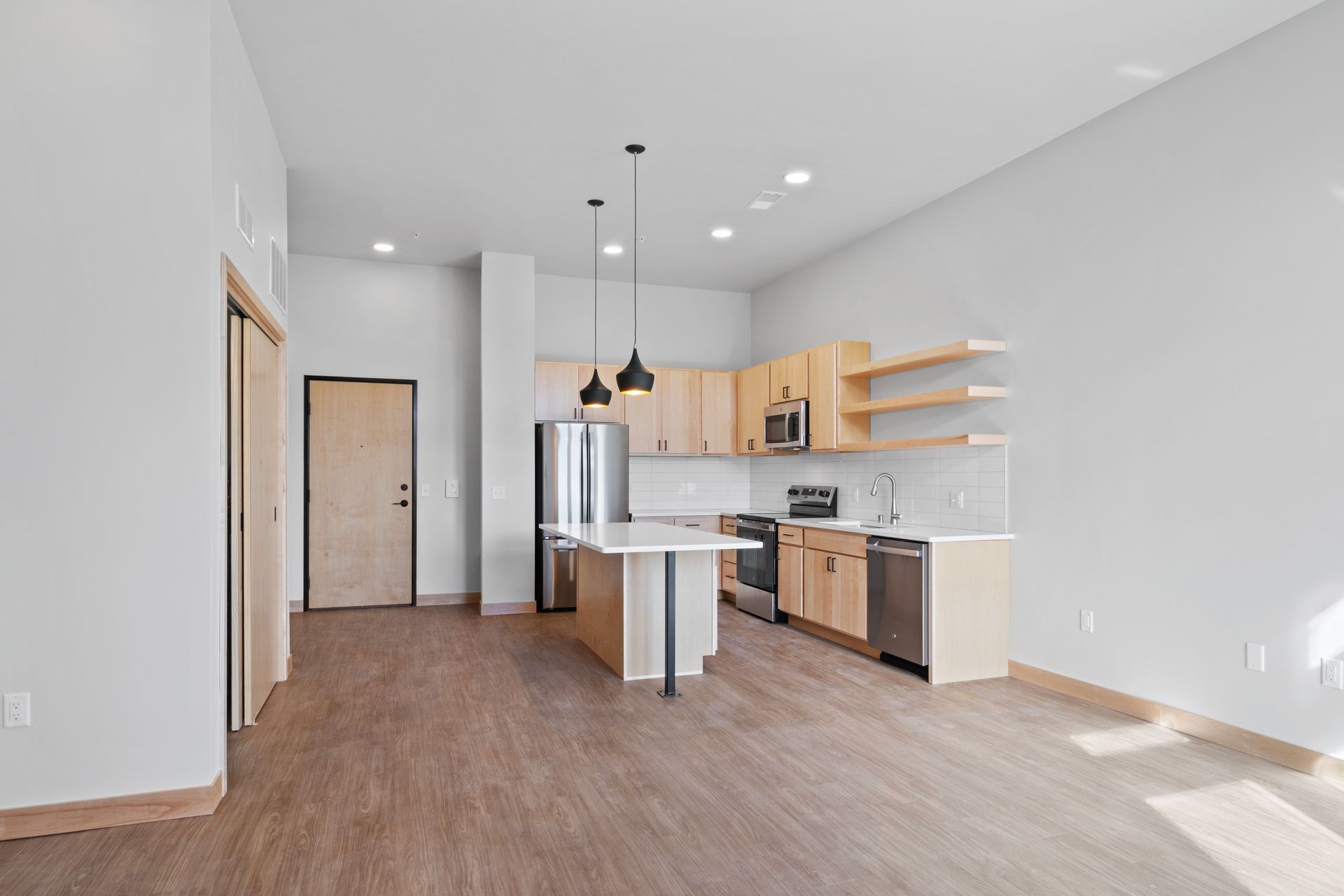 A kitchen with stainless steel appliances and wooden cabinets