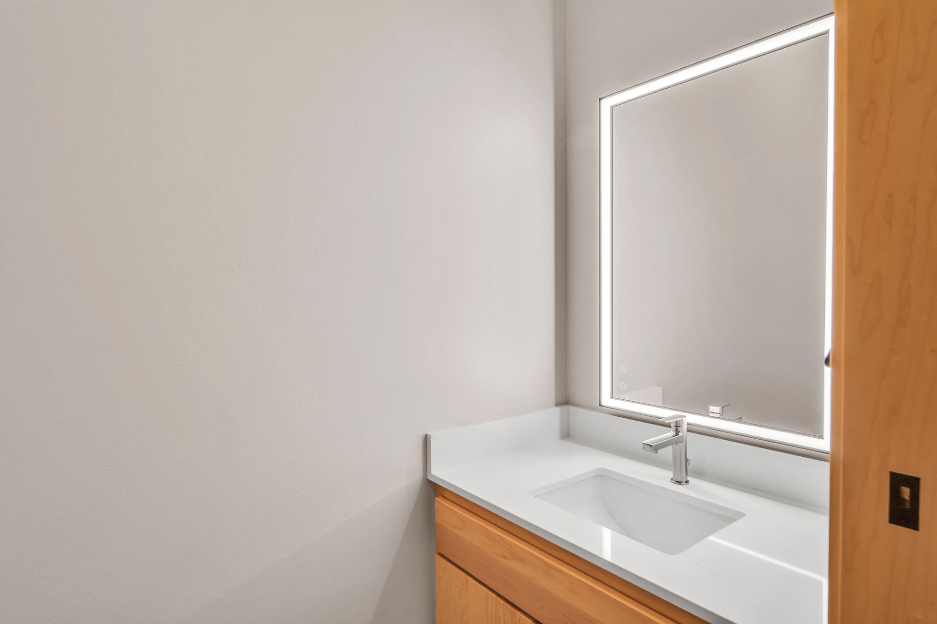 A bathroom with a sink and a mirror.