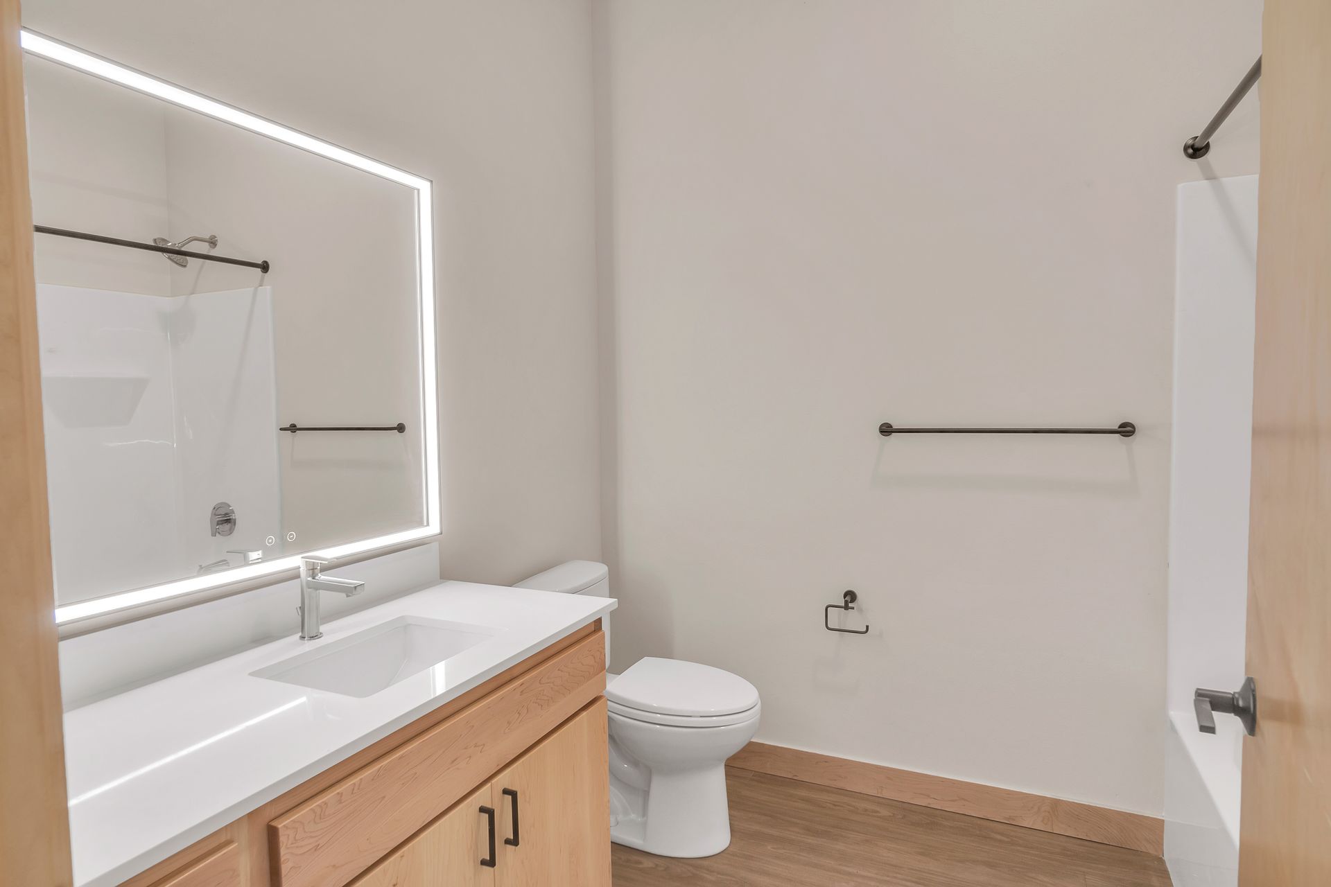 A bathroom with a toilet , sink , and mirror.