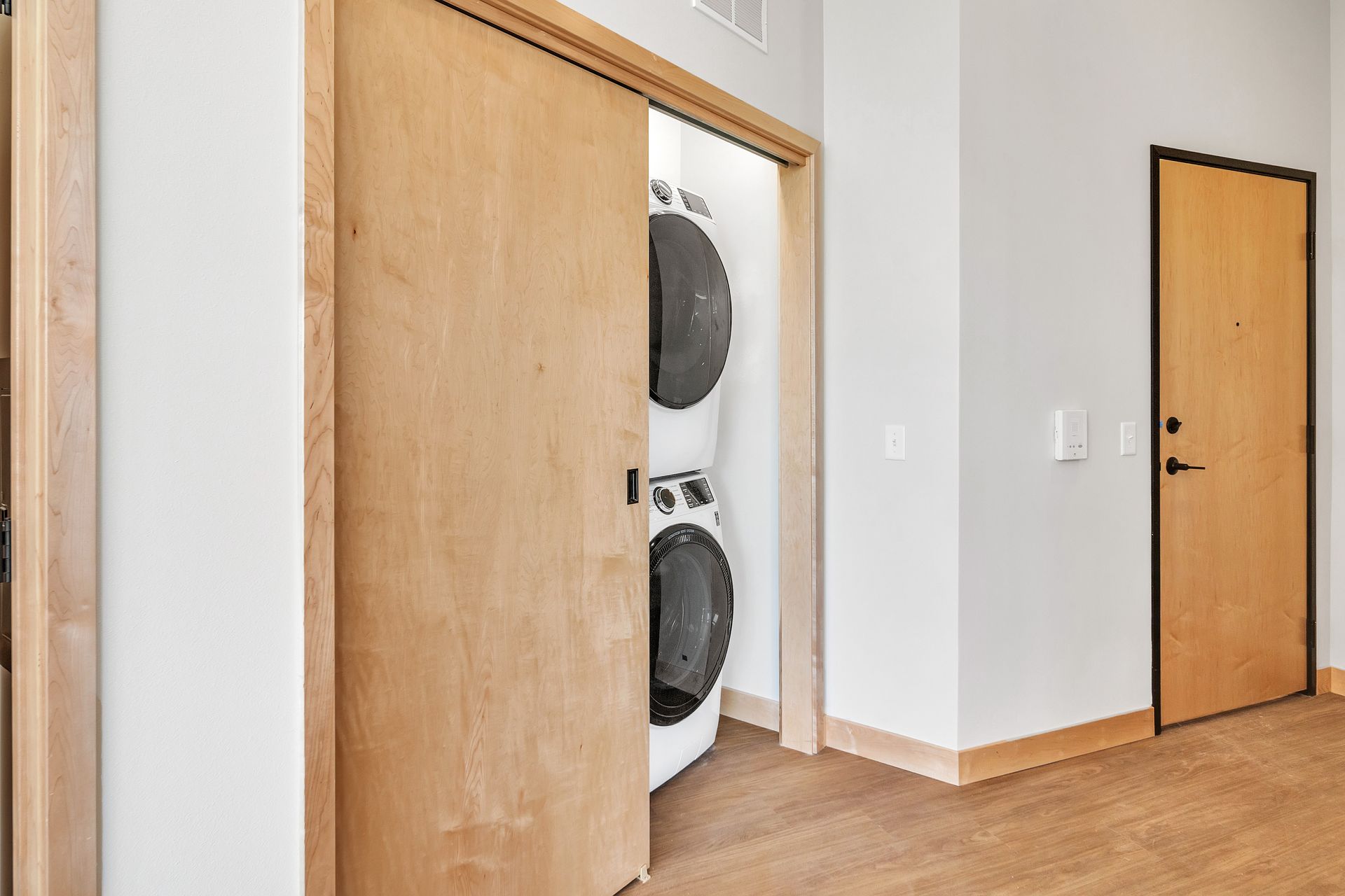 A laundry room with a washer and dryer in a closet.