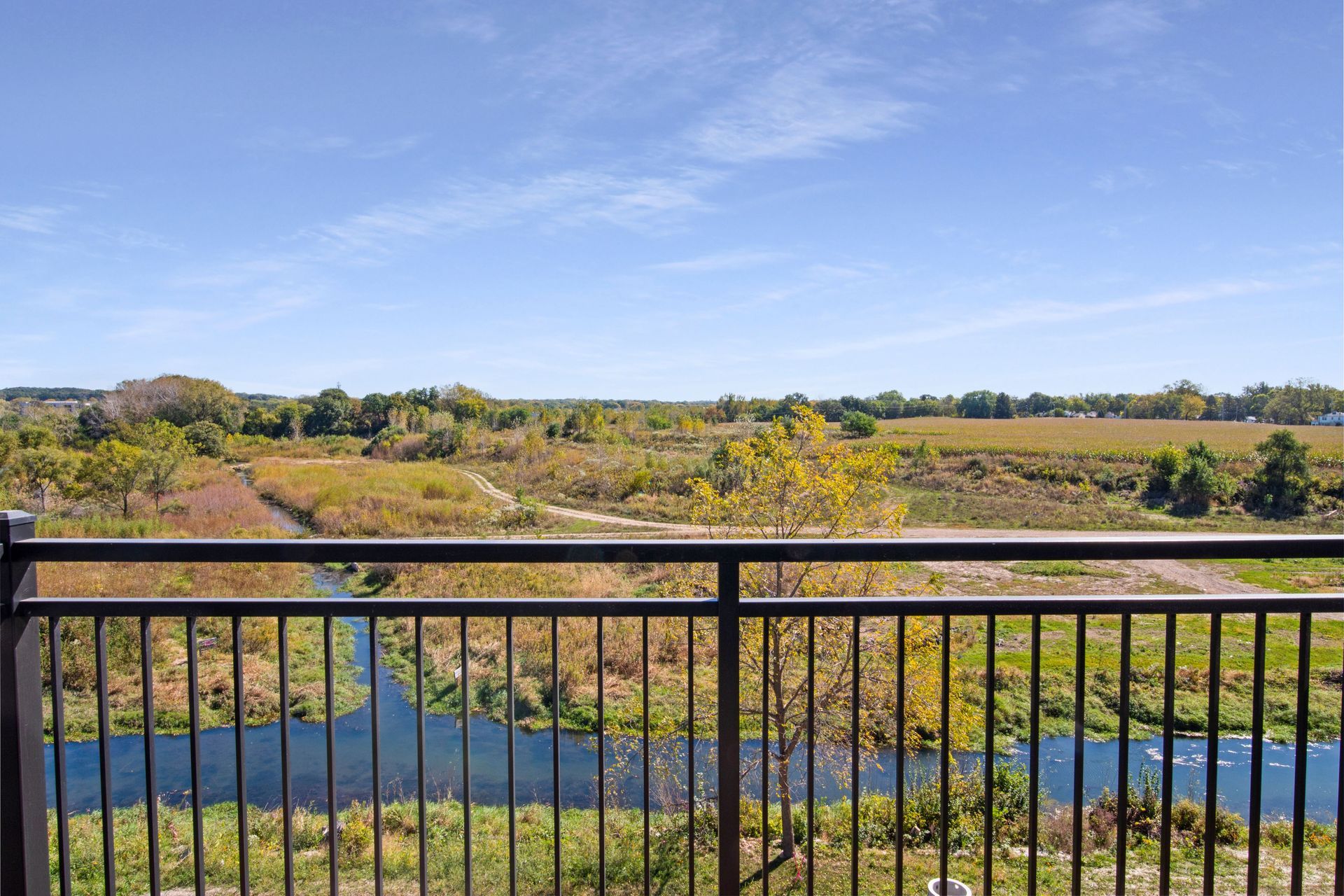 A view of a river from a balcony with a railing.