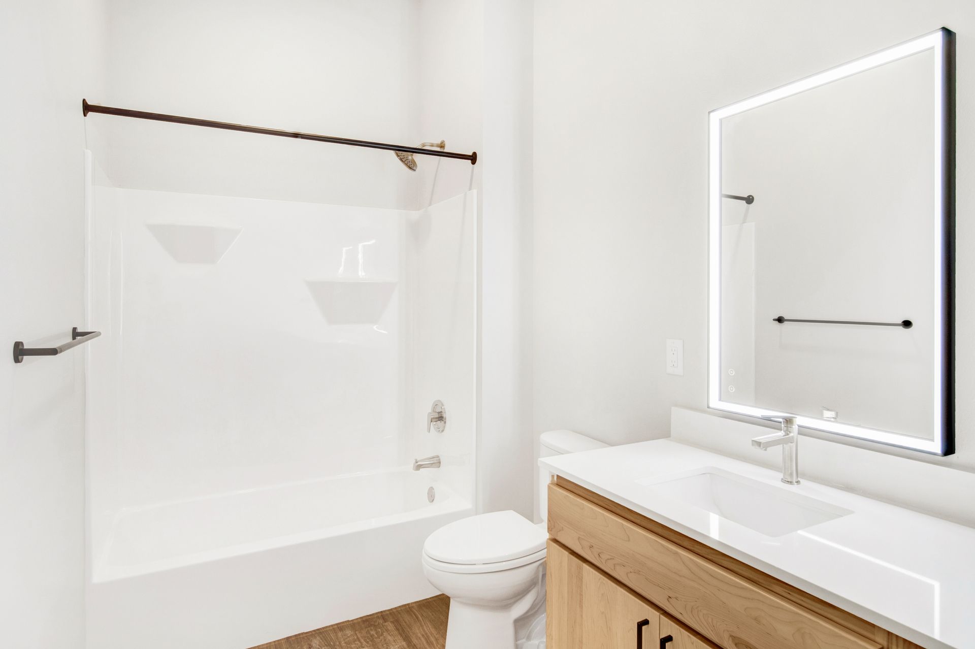 A bathroom with a toilet , sink , and mirror.