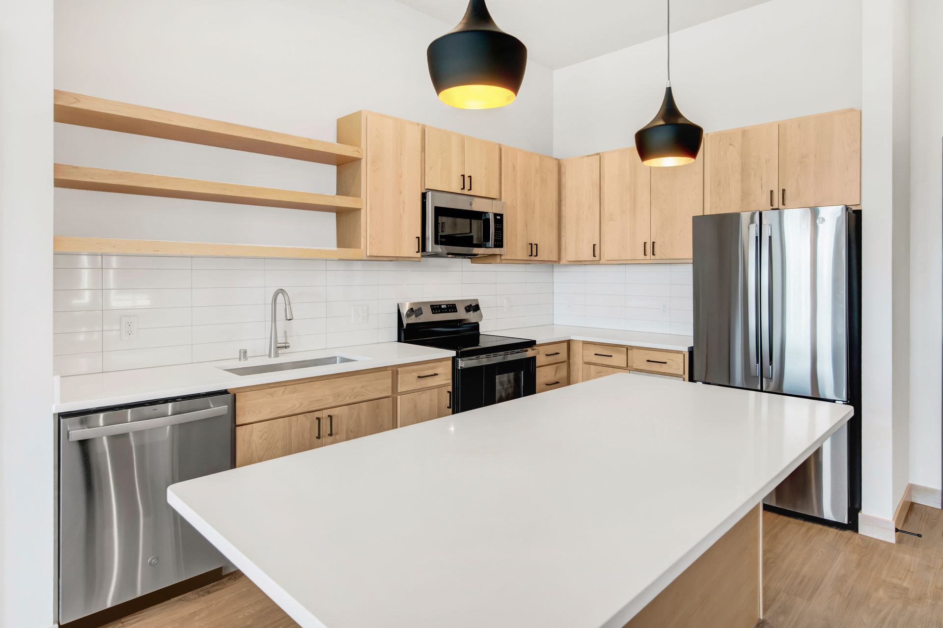 A kitchen with stainless steel appliances and wooden cabinets