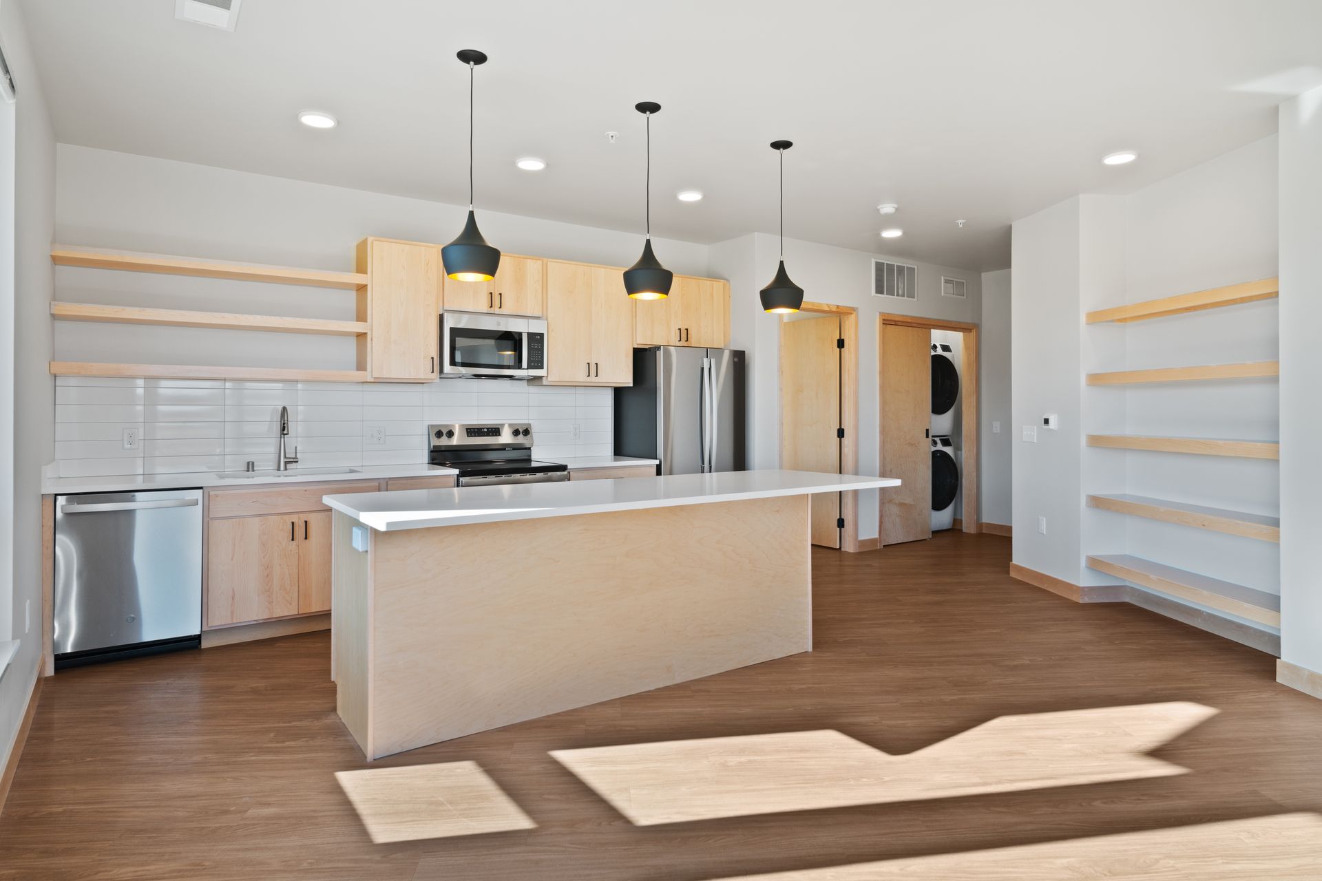 A kitchen with a large island and stainless steel appliances
