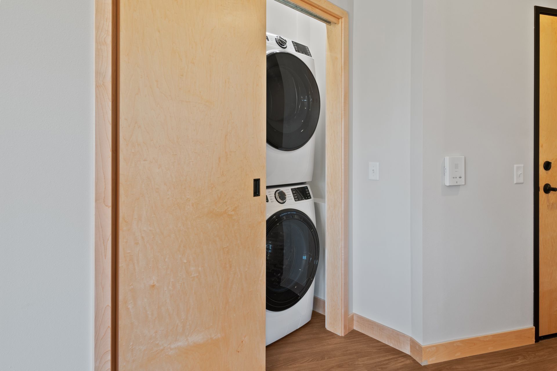 A washer and dryer are stacked on top of each other in closet
